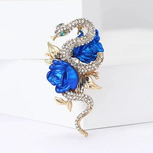Detailed view of snake brooch with sparkling rhinestones and blue enamel roses