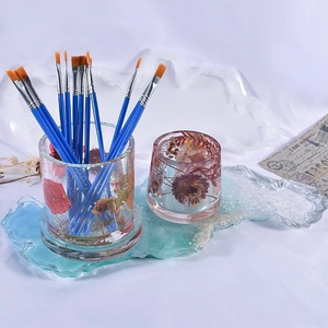 Detailed view of handmade resin set with dried flowers in pen holder and tray