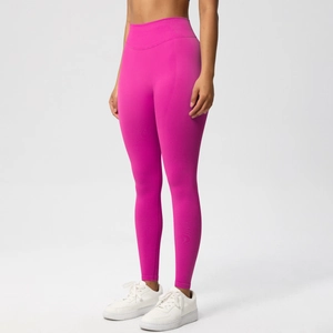 Close-up of seamless high-waisted yoga leggings in vibrant rose red with firm control