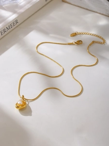 Detailed top view of a gold 18k plated snake chain necklace with freshwater pearl pendant