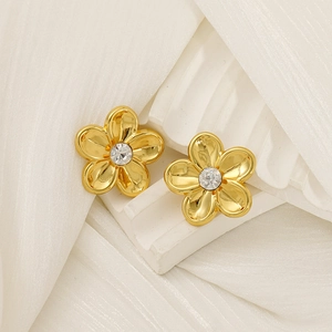 18K gold-plated flower stud earrings with center zircon stones on minimalist white display