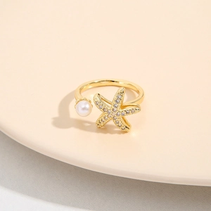 Adjustable 18K gold plated starfish ring with micro-pave crystals and white pearl accent