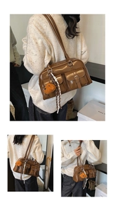 Macro detail of brown leather pillow bag with plush bear charm and silk scarf handle decor