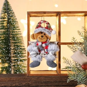 Christmas plush bear ornament with Navidad sign, plaid hat and scarf hanging on wood