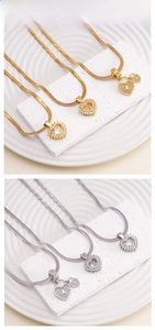 Detailed tile display of heart pendants with pavé zircon settings in gold and silver