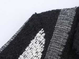 Close-up of the black and white knit fabric texture with vertical striped plush pattern
