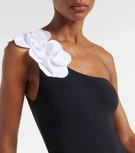 Detail of 3D white floral appliques on a black one-shoulder swimsuit for women