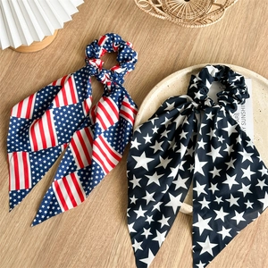 Flat lay of USA flag patterned bow scrunchies on a wooden background with rustic decor