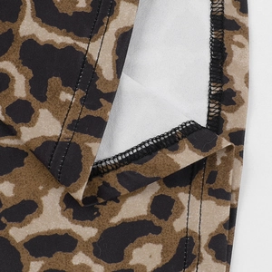 Macro detail of leopard print fabric showing stitching quality and fine textile texture