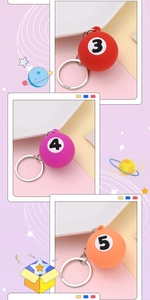 Detailed view of billiard ball keychains in red, purple and orange with metal rings