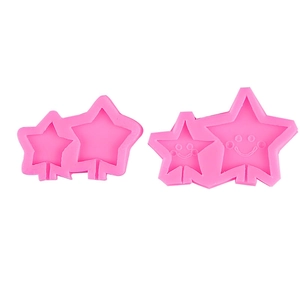Pink silicone star lollipop molds with smooth and smiley face designs for chocolate and cake