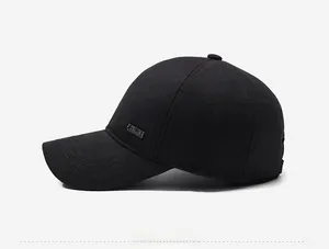 Detail view of winter baseball cap featuring thickened fabric and metal brand emblem