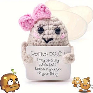 Close-up of handmade crochet positive potato with a pink bow and inspirational card