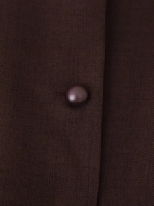 Macro view of dark brown twill fabric texture and polished round button detail