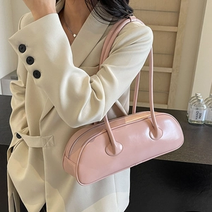 Pink cylinder underarm shoulder bag in glossy PU leather with dual thin straps