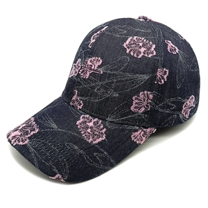 Detail of dark blue denim baseball cap with pink floral embroidery and distressed finish