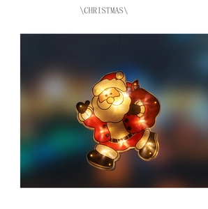 Close-up of LED Christmas Santa hanging light with warm glow and festive bokeh background