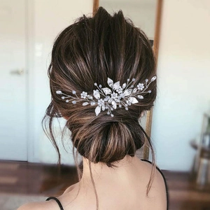 Silver leaf bridal hair comb with pearls and crystals shown on an elegant updo hairstyle