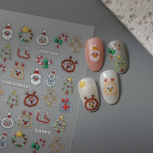 Detailed view of 5D Christmas nail stickers with embossed Santa and reindeer patterns