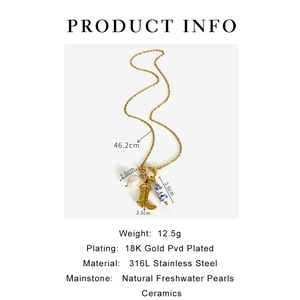 Macro shot of 18K gold plated boot charm with freshwater pearl and porcelain bead detail