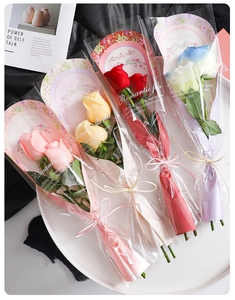 Detail of assorted artificial rose bouquets in pink and red with romantic gift wrap