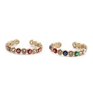 Detail of gold evil eye rings with colorful enamel and sparkling zircon stones