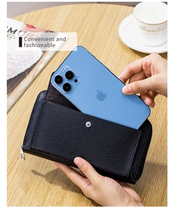Detail view of black lychee texture crossbody phone wallet with metal snap and zipper