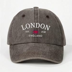 Detailed view of dark grey washed cotton baseball cap with white London England embroidery
