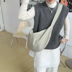 Detail of light green pleated hobo bag showing large capacity and textured fabric surface