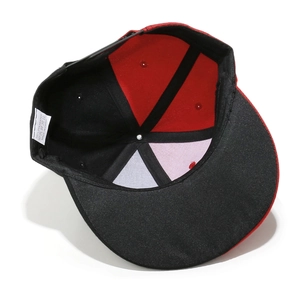 Detail view of the red and black snapback cap showing 100% polyester fabric and seams