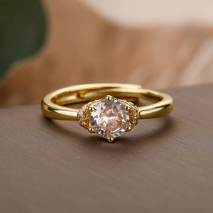 Elegant 18K gold plated copper ring with a round zircon centerpiece and accent stones