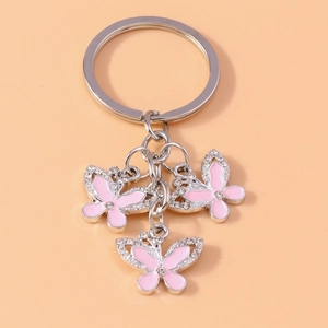 Detail of silver butterfly keychain with pink enamel and sparkling rhinestones