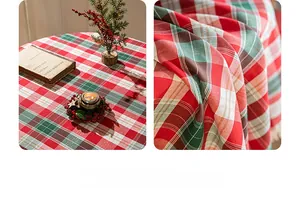 Close-up of red and green plaid Christmas tablecloth with woven texture and fringe trim