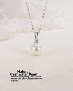 Close-up of S925 silver V-shaped necklace with natural pearl and sparkling zircon pendant