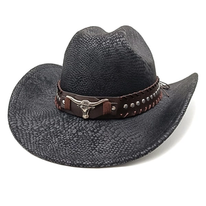 Detailed view of black snakeskin texture cowboy hat with bull head buckle and studs