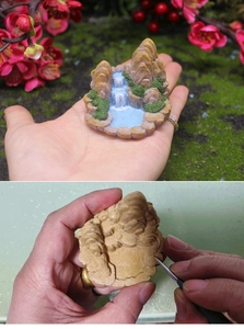 Detailed view of handcrafted miniature rockery mountain resin model with waterfall decor