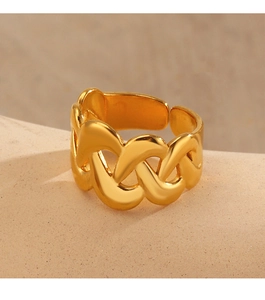 Detailed close-up of 18K gold-plated twisted chain ring on beige stone texture