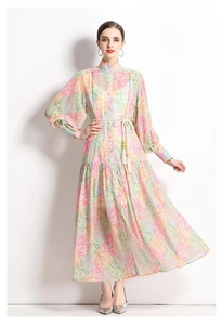 Detail of bohemian patchwork dress featuring colorful vintage prints and tassel drawstring