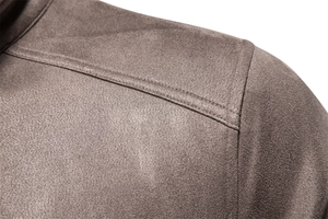 Detail of reinforced double-needle stitching on dark brown faux suede jacket shoulder