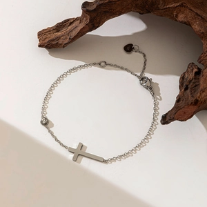 Elegant 18K silver cross bracelet with a single diamond charm on a minimalist thin chain