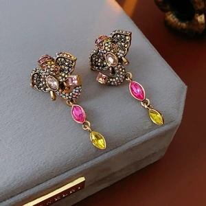 Detailed shot of vintage elephant earrings with colorful rhinestones and teardrop gems