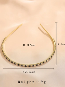 Detailed view of emerald cubic zirconia headband with 14.7cm height and 19g weight specs