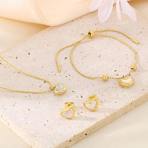 Elegant gold-plated jewelry set with heart-shaped white shell necklace, bracelet, and studs