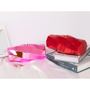 Chic irregular geometric clutch bag in bright pink and red with metallic mirror finish