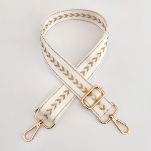 Adjustable white nylon shoulder strap with gold arrow embroidery and metal buckles
