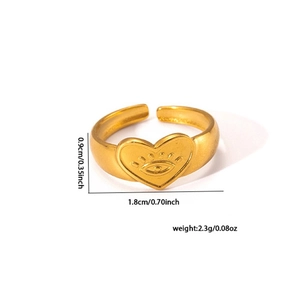 Macro detail of gold-tone heart ring showing etched eye motif and 1.8cm width dimensions