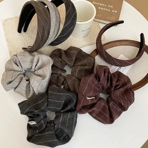 Minimalist striped fabric scrunchie and headband set in warm autumn colors for women