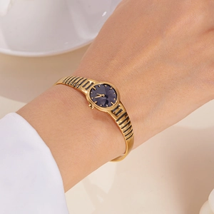Elegant gold-tone bangle watch for women with a minimalist deep blue dial face