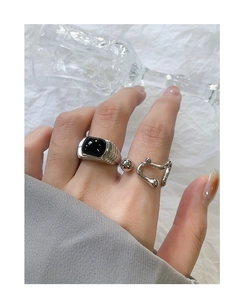 Close-up of S925 silver ring featuring step-cut black onyx and wavy irregular band