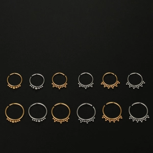 Detail view of 12 pieces of 316L stainless steel nose rings in gold and silver finish